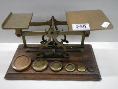 A good set of brass post office scales with weights.