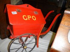 An old wooden toy hand cart with lift up side, marked GPO, COLLECT ONLY.
