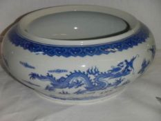A Chinese blue and white bowl decorated with dragons.