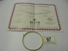 An 18ct gold bangle with certificate, 7.5 grams.