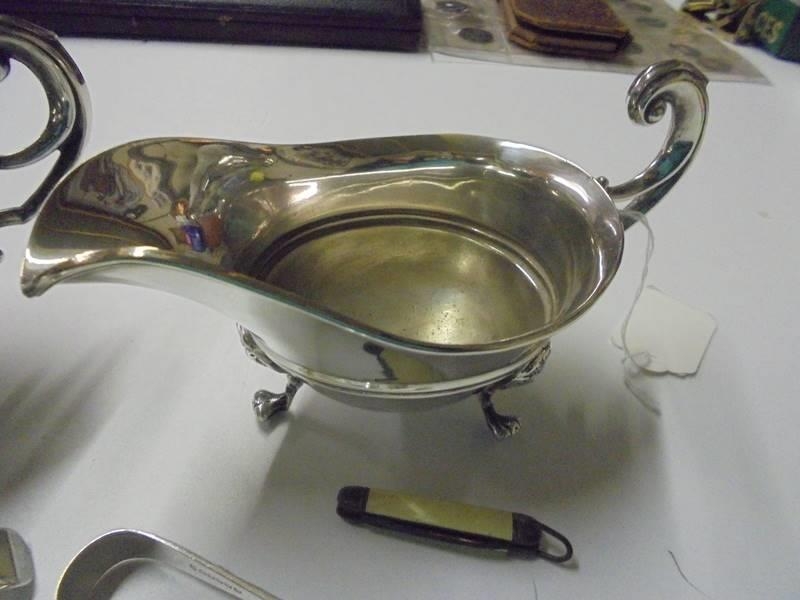 A pair of silver plate sauce boats, spoons, sugar nips etc., - Image 2 of 3