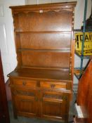 An open rack oak dresser with two cupboards and two drawers, COLLECT ONLY.