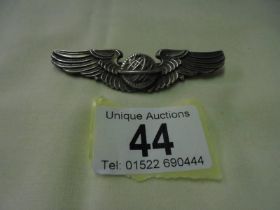 A silver 'Wings' brooch.