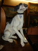 A seated figure of a Whippet dog.