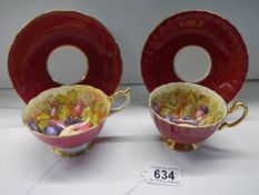Two Aynsley Orchard Gold teacups and saucers signed D Jones.