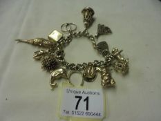 A 9ct gold charm bracelet with forteen charms, 71 grams.