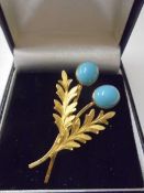 A superb quality yellow metal brooch set turquoise coloured stones stamped 12k.