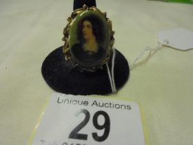 A porcelain portrait brooch in a gilt metal mount.