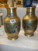 An early pair of brass and enamel vases.