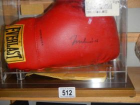 A cased Mohamed Ali signed boxing glove.