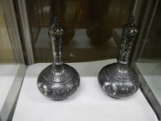 . A beautiful pair of 19thC silver-inlaid Bidri lidded Surahis with fish and foliage design.