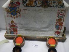 A deed box with deed and a pair of wax seals in boxes.