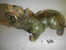 A powerful Chinese jade figure of a mythical lion. H 13cm x W 20cm.
