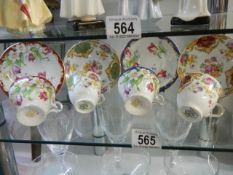 A collection of colourful tea cups and saucers.