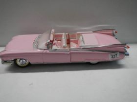 A 1/12 scale pink Cadillac car.