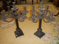 A pair of heavy iron candelabra.