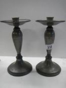 A pair of Tudric pewter candlesticks.