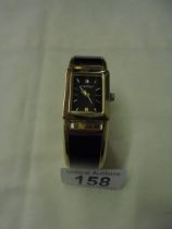 A Caravelle New York black enamel bangle watch.