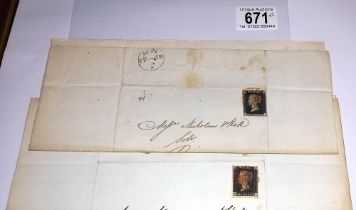 Two mid 19th century penny black postage stamps on postmarked envelopes.