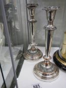 A pair of silver plate on copper candlesticks.