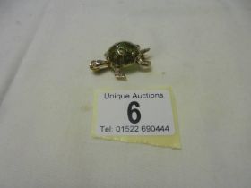 An 18ct yellow gold diamond and emerald tortoise brooch, 10.8 grams.