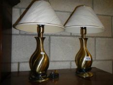 A pair of gilded ceramic table lamps.