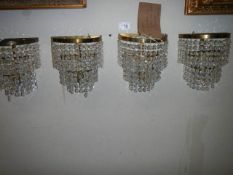 A set of four three tier wall lights.
