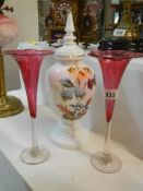 A pair of cranberry glass vases and an opaline glass lidded vase.