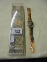 A Swatch Access cased wristwatch with multicoloured strap.