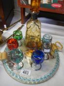A retro glass decanter with six painted glasses on a tray, COLLECT ONLY.