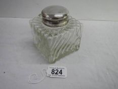 A 3.5" square 19th century silver topped glass inkwell with handle.