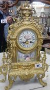 A French ormolu mantel clock with enamel dial and porcelain panel.