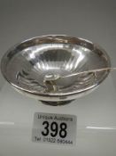 A small silver dish with spoon.