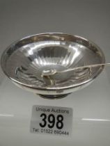 A small silver dish with spoon.