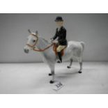 A Beswick horse with black jacket huntsman, 23 cm tall.