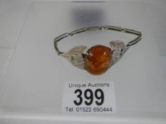 A Danish silver bangle set amber.