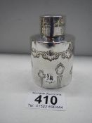 A small embossed silver hall marked bottle.