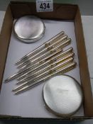 Two silver compacts and six ball point pens all marked 915.