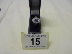 An 18ct gold oval sapphire and diamond ring, size M half, 3.6 grams.