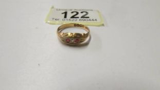 An 18ct gold diamond and ruby ring, size O, 2,2 grams.