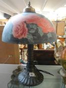 A good quality table lamp with rose decorated glass shade. COLLECT ONLY.