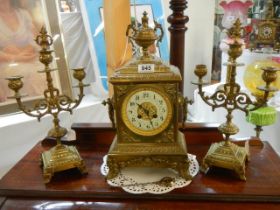 A three piece brass clock garniture in working order.