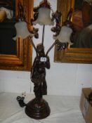 A three light figural table lamp. COLLECT ONLY.