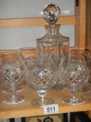 A cut glass decanter and a set of six cut glass brandy goblets.