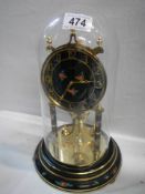 A good Kundo anniversary clock under glass dome, in working order, COLLECT ONLY.