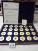 A limited edition cased set of 24 gold plate on copper Queen Elizabeth II coins.