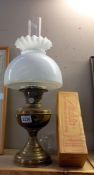 A vintage brass oil lamp and shade, plus a boxed Aladdin Loxon chimney