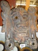 An old carved wood tribal mask.