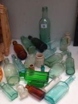 A quantity of 19/20c vintage glass bottles including green poison etc