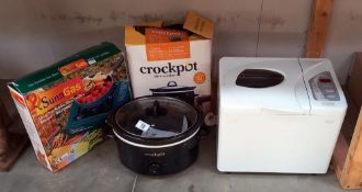 A bread maker, crock pot and portable gas stove